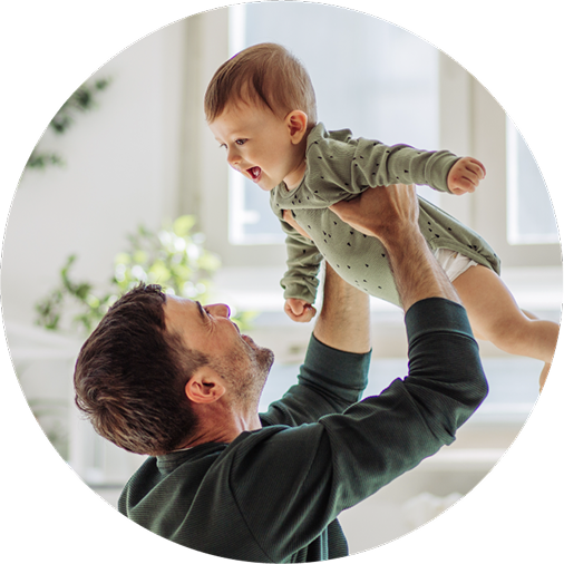 A proud dad playing with his toddler